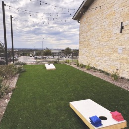cornhole game in courtyard area